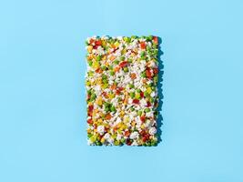 Frozen vegetables assorted on blue, top view photo