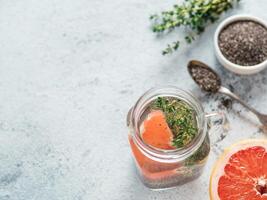 grapefruit and thyme chia water in mason jar photo