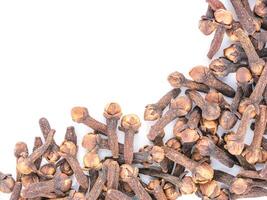 Cloves spice on white background with copy space. Isolated one edge. Top view or flat lay. photo