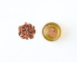 Linen seeds and linen raw oil isolated, top view photo