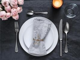 Beautiful table setting on gray linen tablecloth photo