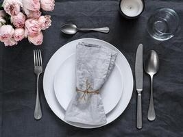 Beautiful table setting on gray linen tablecloth photo
