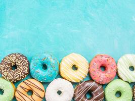 donuts on blue background , copy space, top view photo