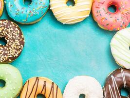 donuts on blue background , copy space, top view photo