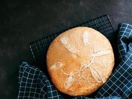 Wheat round sourdough bread, copy space, top view photo