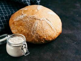 Sourdoug starter and wheat bread, copy space photo