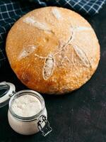 Wheat round sourdough bread, copy space, vertical photo