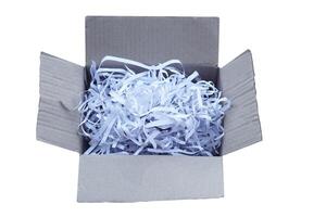 Box contains sliced used paper to be small stripes, prepare to recycle process. isolated on white background.Concept, Waste or garbage management. Documents shredded for security purposes. photo