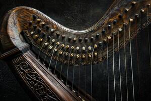 Antique celtic harp made from dark wood showing tuning pins and strings photo