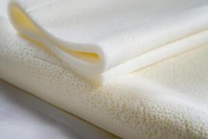 White memory foam folded on white background photo