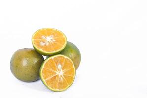 Green orange fruit or Tangerine orange with cut in half isolated on white background. Clipping path photo