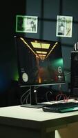 Vertical Professional gaming empty room studio with neon lights and RGB lit computer next to headphones and VR headset. Dolly in shot of FPS videogame on pc display and virtual reality goggles in apartment video