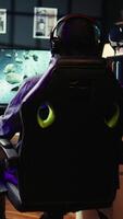 Vertical Player at home shooting asteroids in spaceship flying singleplayer game with overlay HUD showing health levels on monitor. Close up of person navigating universe in simulation game on PC video
