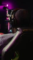 Vertical Heartbroken gamer dejected after losing in online multiplayer videogame, being defeated by rivals. Man putting hands on head in frustration after seeing game over screen on gaming pc monitor, camera B video