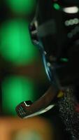 Vertical Man playing SF videogame on computer, having fun in neon lit apartment, close up. Gamer competing in online multiplayer game, using headphones to talk with teammates, camera A video