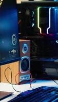 Vertical RGB lights illuminated fans on gaming computer capable of playing latest games, close up shot, empty apartment. Focus of components on powerful desktop PC in home living room video