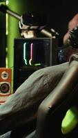 Vertical Man playing SF shooter videogame on computer monitor, talking into headset with friends. Gamer using headphones while enjoying game with spaceship flying to chat with Esports team, camera B video