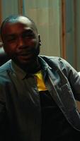 Vertical African american man teaching subscribers professional esports skills and how to play game. Media star on gaming chair chatting with viewers, filming gaming tutorial, camera B video