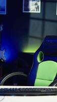Vertical POV of happy man entering room, playing FPS videogame on PC screen in neon illuminated apartment living room. Joyous gamer coming home to enjoy game on computer in RGB lit house, camera B video
