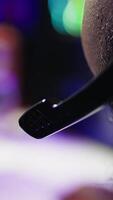 Vertical Man having fun playing videogames on PC while chatting with teammates through headphones mic. Close up of gamer battling rival players, communicating with friends through headset microphone, camera B video