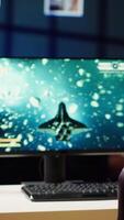 Vertical Man coming home to play SF space videogame on PC screen after finishing job shift. Gamer entering room, starting spaceship flying game on computer in RGB lit home late at night, camera A video