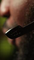 Vertical Man having fun playing videogames on PC while chatting with teammates through headphones mic. Close up of gamer battling rival players, communicating with friends through headset microphone, camera A video