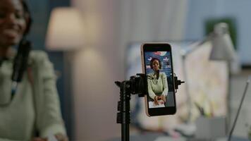 Social media woman talking at professional microphone while recording podcast for youtube channel at smartphone. Creative online show On-air production internet broadcast host streaming live video