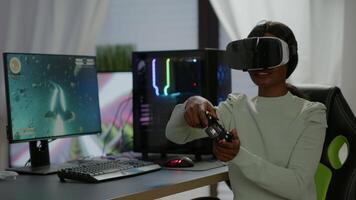Winner player holding joystick playing videogame in gaming room using virtual reality. Professional pro gamer streaming online videogames with new graphics on powerful computer using modern equipment. video