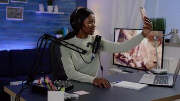 Influencer doing vlog production with professional smartphone in home studio. Online show On-air production internet broadcast host streaming live content, recording digital social media communication video