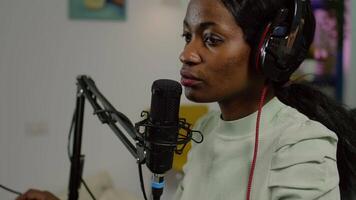 Black vlogger on air during podcast channel using mixer checking sound and professional microphone. Online show production internet broadcast host streaming live , recording social media content video