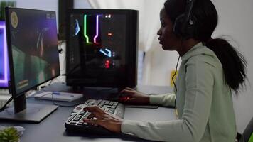 Upset videogame african player losing online videogame competition wearing professional headset. Sad gamer using powerful RGB computer for gaming tournament late night playing space shooter game video