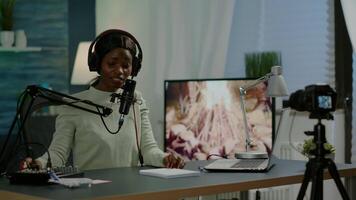 Famous vlogger making online podcast recording for virtual show in front of camera. Influencer using headphones speaking at microphone. On-air production internet broadcast show host streaming video