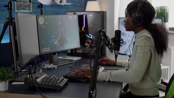 Pro african streamer losing space shooter videogame at live competition playing from home studio. Online streaming cyber performing during gaming tournament using powerful computer with RGB lights video