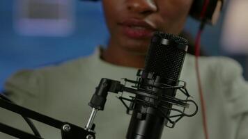 Close up of famous woman recording a vlog for subscribers using podcast microphone for vlogging. On-air online production internet broadcast show host streaming live content for social media video