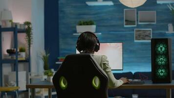 Angry african pro woman gamer losing space shooter videogame during online championship. Cyber player testing virtual games using powerful personal computer in gaming room during esports tournament video