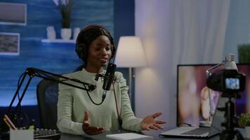 Influencer making online internet content for web subscribers using camera in home podcast studio during livestreaming. On-air online production broadcast show host streaming live content video