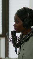 Vertical . Sad black woman gamer with headphone streaming videogames in gaming home studio losing competition. Professional player talking with other players online for game playing on powerful computer video