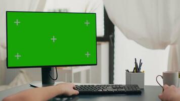 Pov of man hands typing on keyboard for marketing project using computer with mock up green screen chroma key. Caucasian using isolated pc during online business meeting in living room video