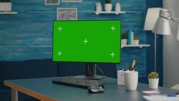 Modern computer with mock up green screen chroma key set up for personal business work. Professional pc with isolated display sitting on office desk in home office with nobody in it video