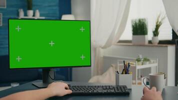 POV of caucasian man working on business conference using isolated pc. Male looking at computer with mock up green screen chroma key sitting on desk in living room video