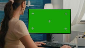 Close up of business woman use personal computer with mock up green screen chroma key. Freelancer sitting on chair at office desk working at financial graphs using isolated pc video