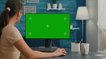 Woman looking at computer with green screen mock up chroma key display working at business commerce, Caucasian female using powerful isolated pc while collegue reading in background video