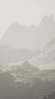 A misty mountain range engulfed in a mysterious fog video