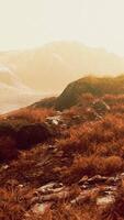 A serene mountain landscape with a beautiful green field in the foreground video