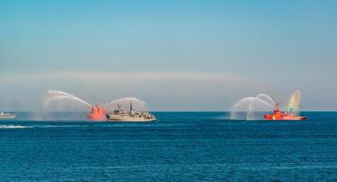 ODESSA, UKRAINE - JUNE 03, 2020 - training of fire ships in the Black Sea, a stream of water throws from the ship photo