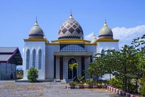 Photos of mosques and gardens set against a blue sky on a sunny day