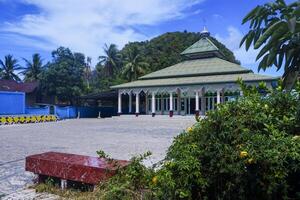view of the mosque with a wide expanse of mountains and blue sky photo