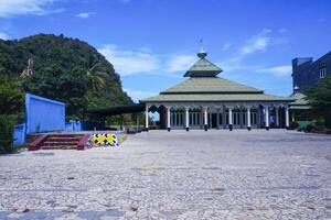 view of the mosque with a wide expanse of mountains and blue sky photo