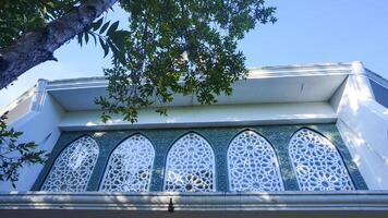 Artistic photo of a mosque wall which has the impression of Islamic religious symbols