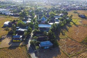 Photos of views of villages and rice fields during the dry season are displayed